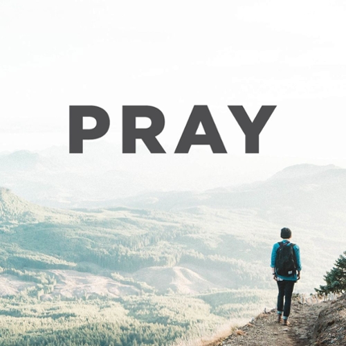 image of person on mountain with the word pray